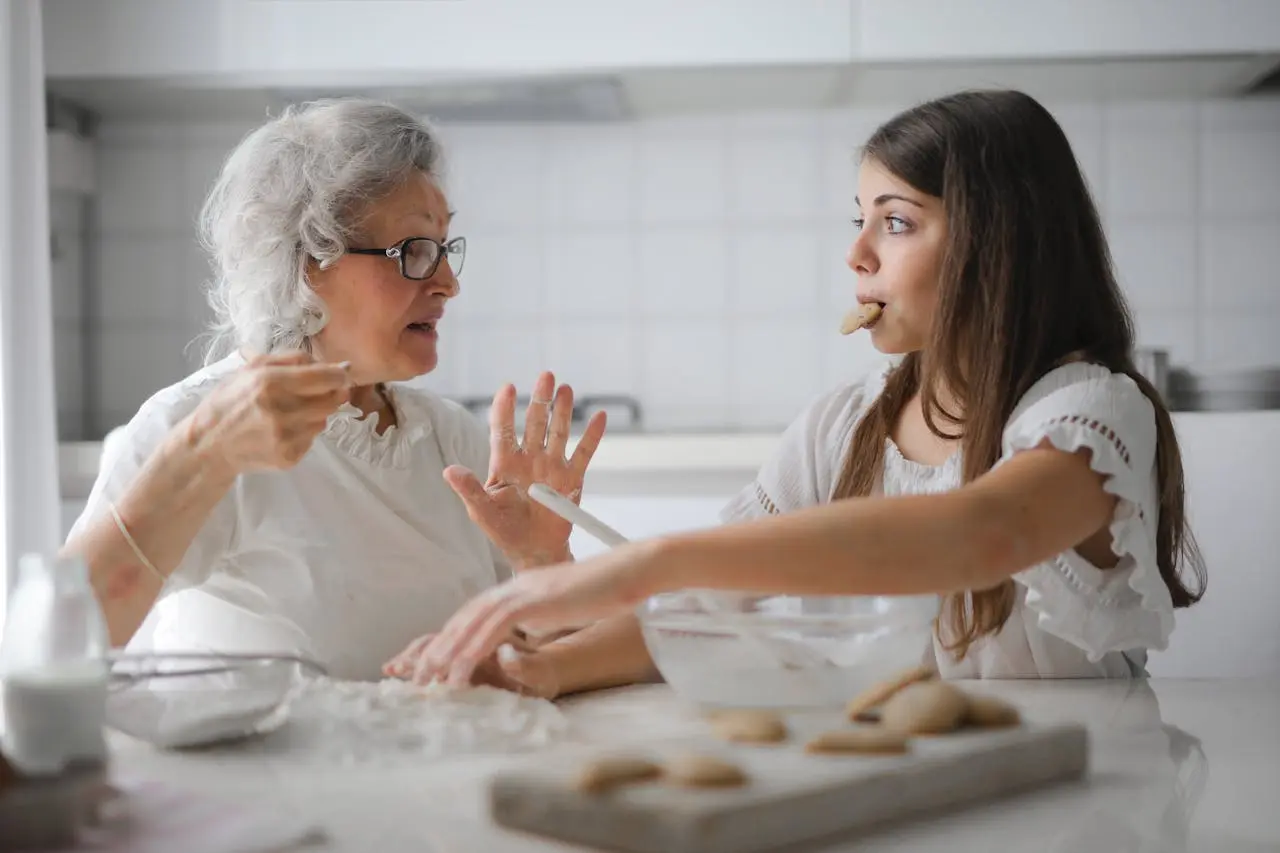 Elderly lady and a girl eating