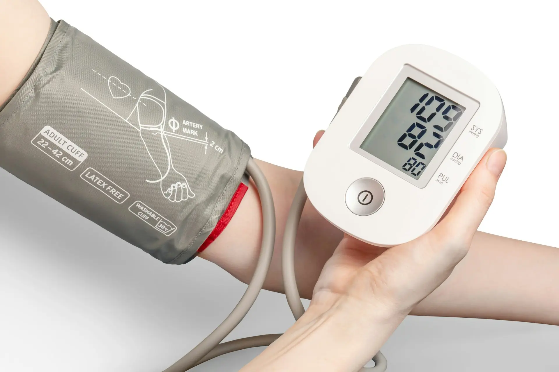 Person checking blood pressure with a digital monitor to manage hypertension effectively at home