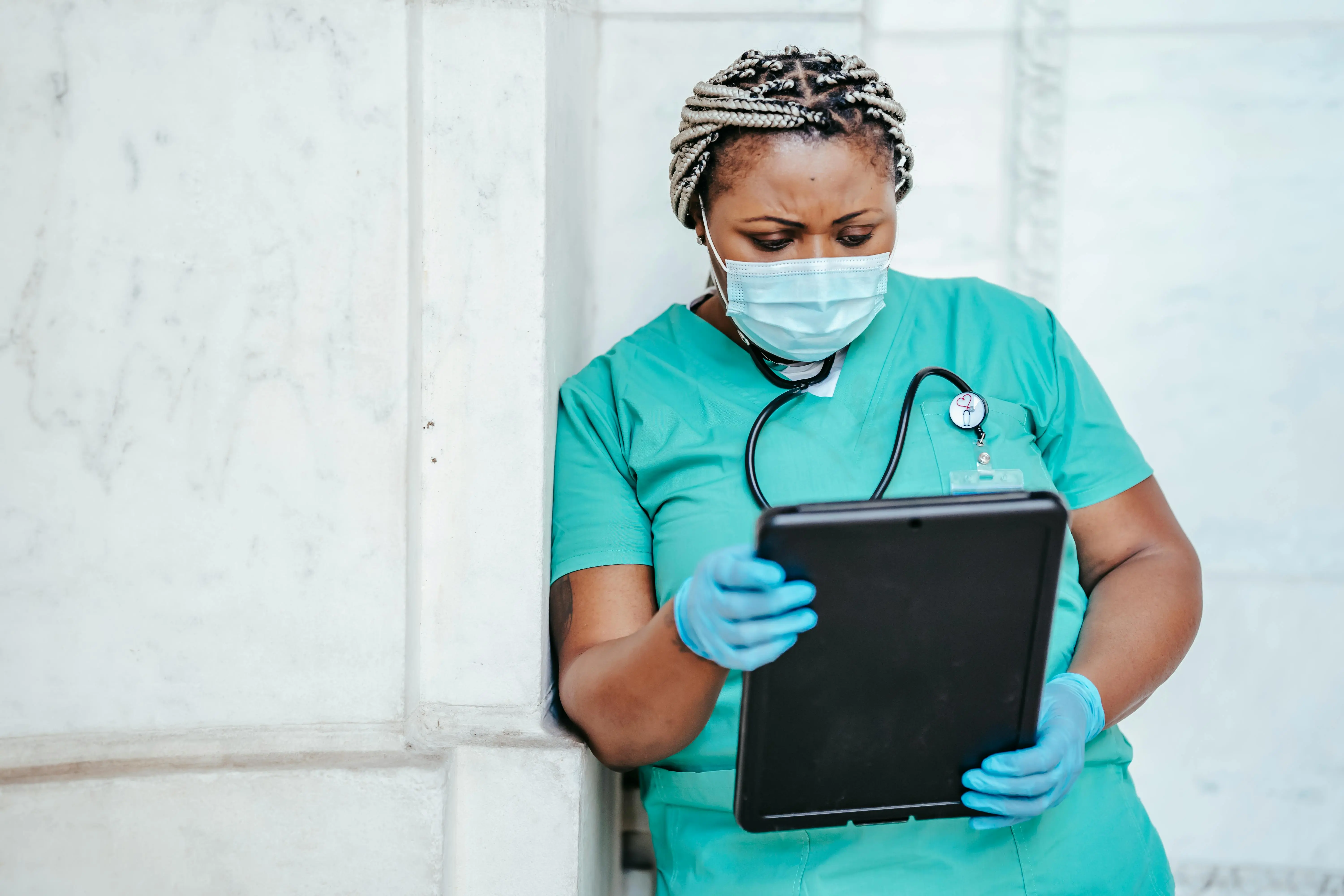 Home care nurse in Coimbatore reviewing patient records on a tablet, providing personalized healthcare services with professionalism and compassion.