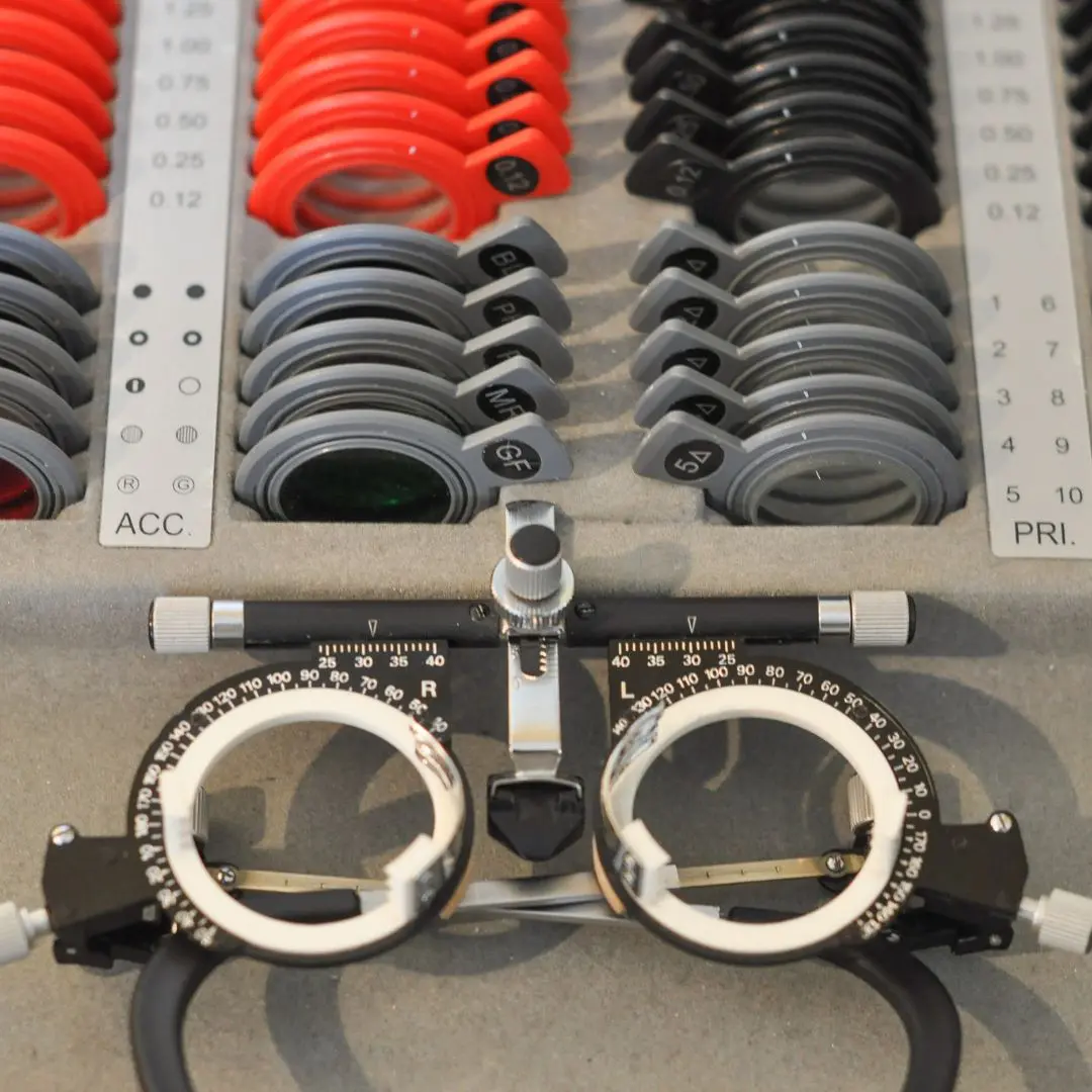 A detailed view of low vision testing equipment, including trial lenses and optometry tools, used for diagnosing and assessing visual impairments.