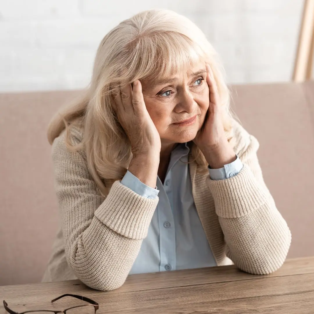 Senior woman experiencing cognitive confusion, representing symptoms of dementia or delirium.