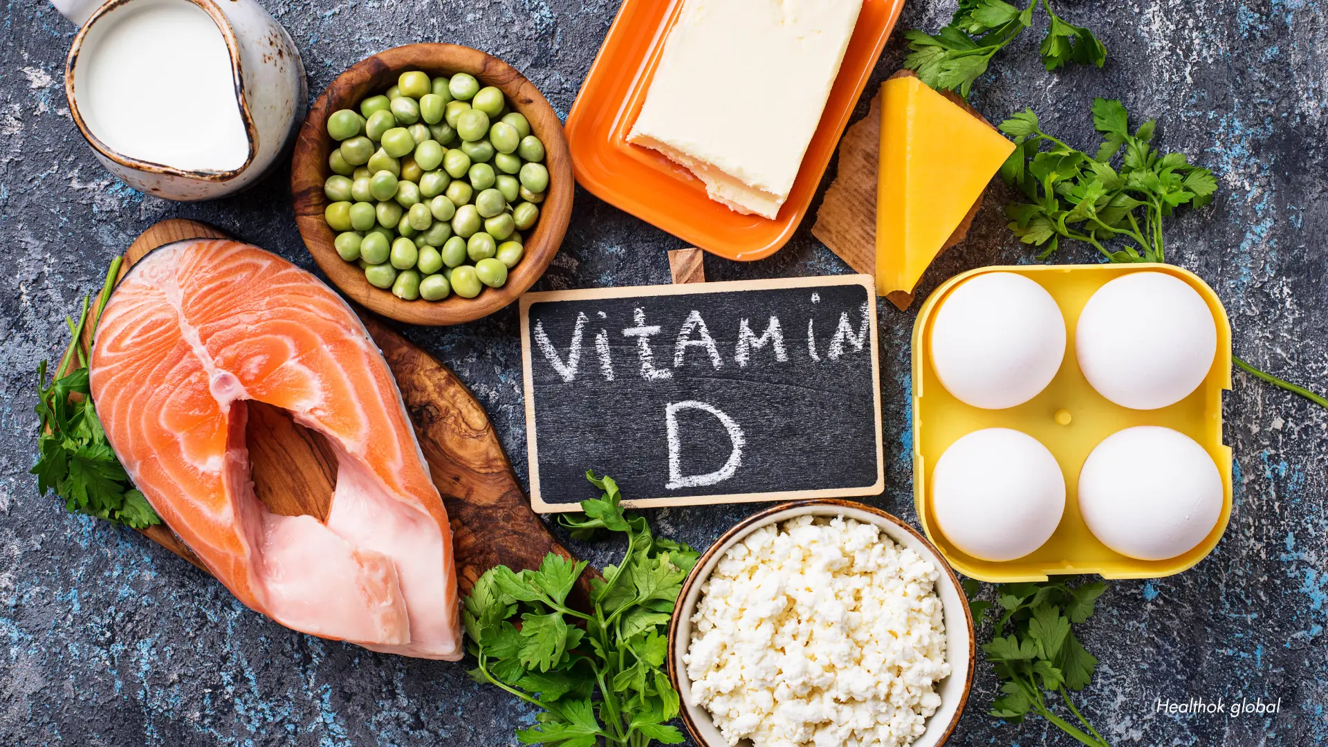 Top view of vitamin D-rich foods, including salmon, eggs, milk, cheese, peas, and cottage cheese, arranged on a textured surface to highlight sources of Vitamin D for healthy bones and immunity.